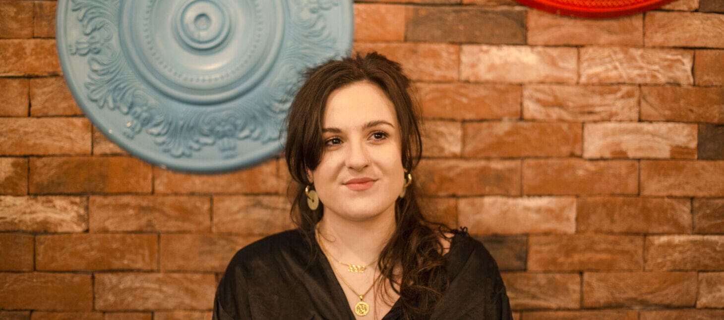Scarlett Kefford against a brick background