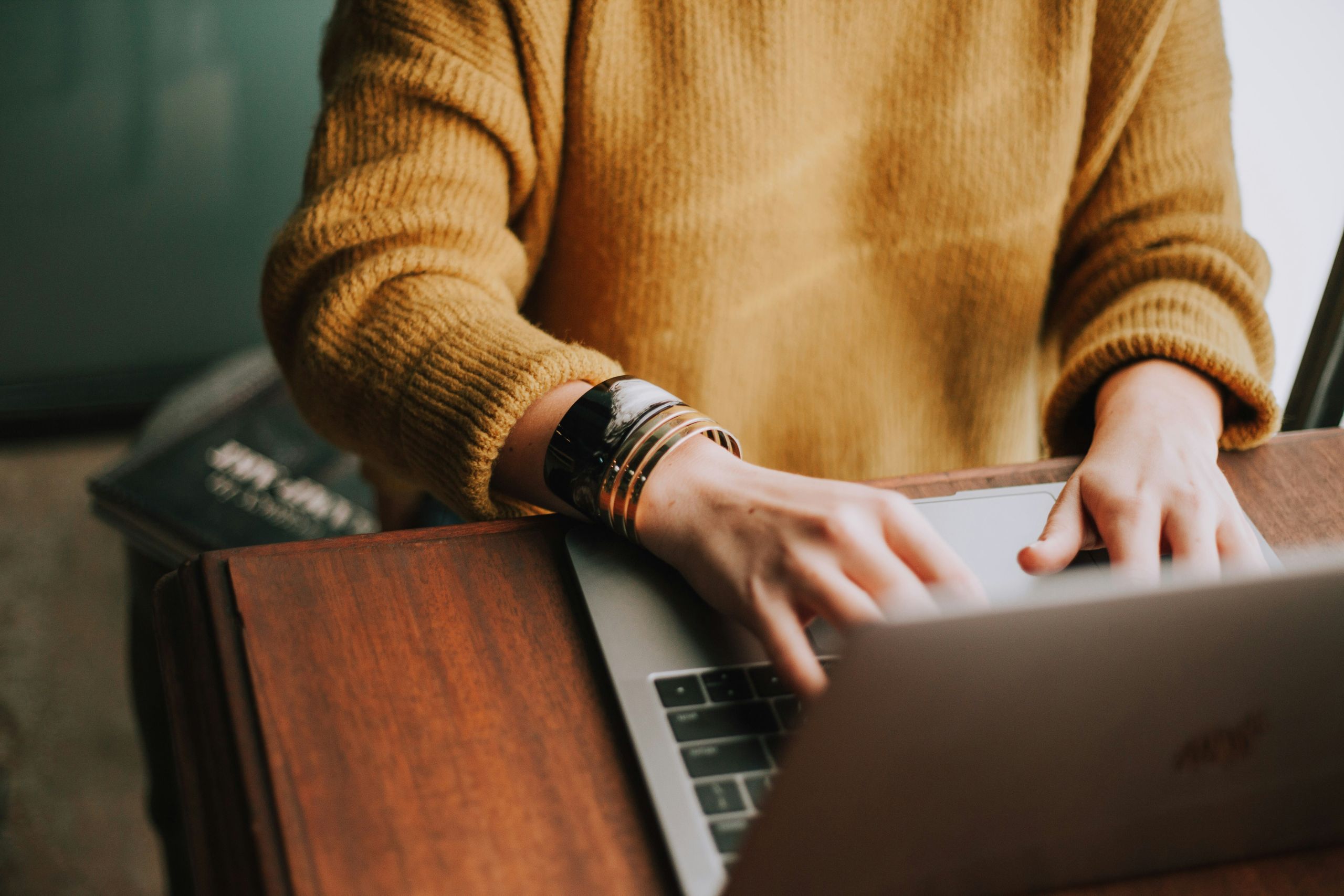 woman writing on laptop